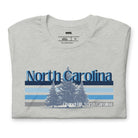 Serene Chapel Hill pine tree design with "North Carolina" and blue and white stripes on a grey graphic tee.