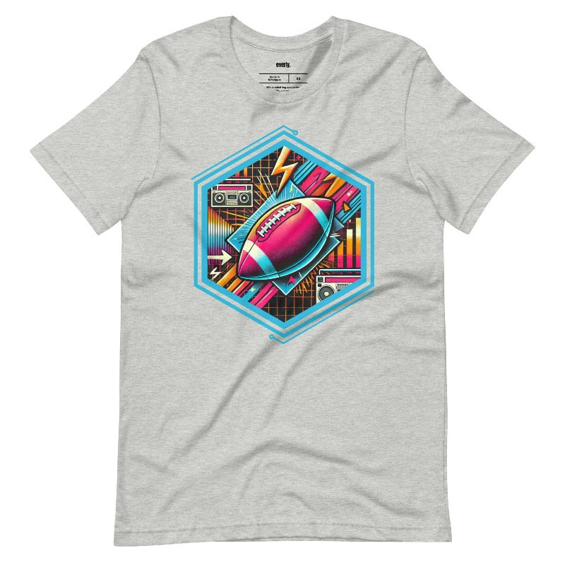 a vibrant neon design of a football with retro elements like boomboxes and geometric patterns, set in a hexagonal frame on a grey shirt.