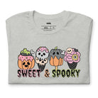 Grey t-shirt featuring a fun 'Sweet & Spooky' design with Halloween-themed ice cream cones, skulls, pumpkins, and spooky treats.