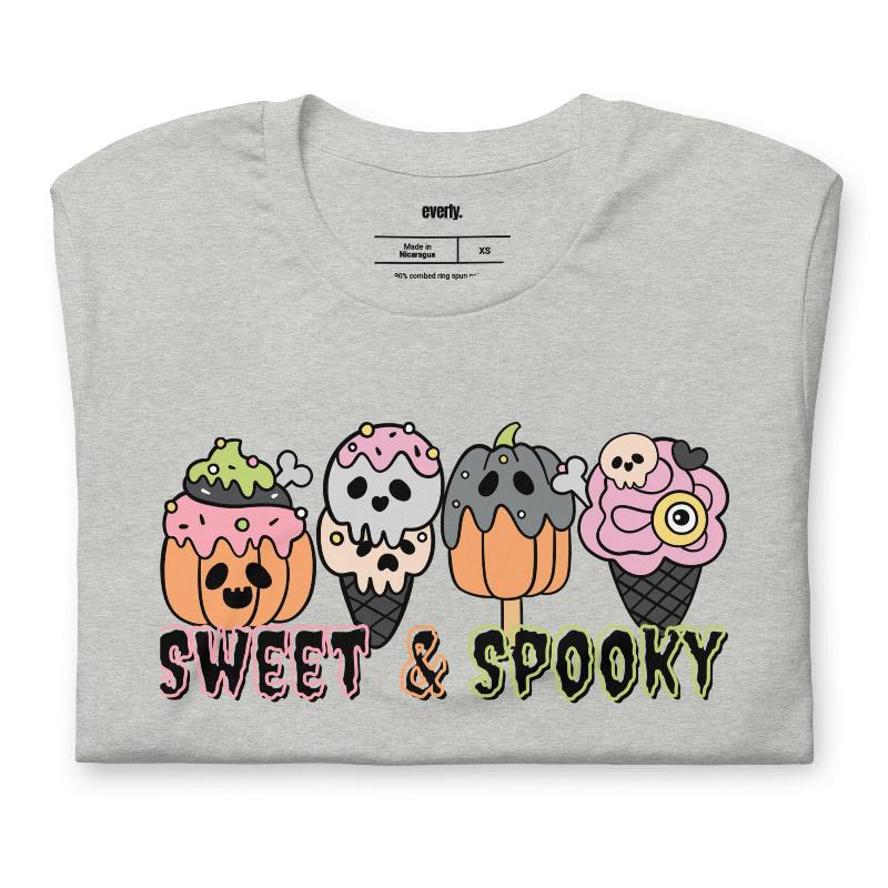 Grey t-shirt featuring a fun 'Sweet & Spooky' design with Halloween-themed ice cream cones, skulls, pumpkins, and spooky treats.