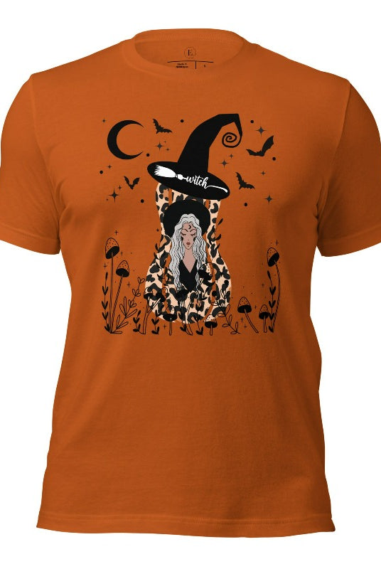 Elevate your Halloween style with our striking shirt featuring a cheetah print squash and a stylish lady donning a witch hat adorned with flowers and bats. Embrace the enchanting fusion of nature and magic on an autumn colored shirt. 