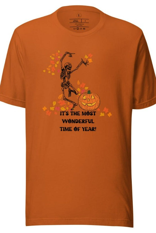 Dancing Skeleton in fall leaves with a jack-o-lantern with saying "It's the most wonderful time of year" on a autumn colored shirt.