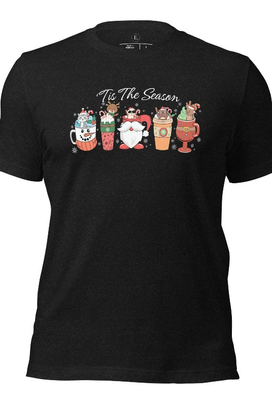 Wrap yourself in cozy holiday vibes with our Christmas coffee cup shirt. With a festive design that says "Tis The Season," this shirt captures the essence of warmth and joy on this black heather colored shirt. 