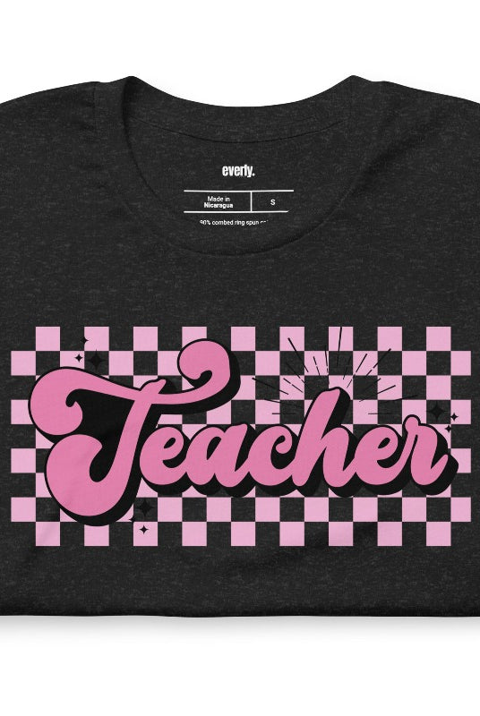 Retro lettering design with the word 'teacher' on a checkered background, featured on a teacher graphic tee. Perfect for teacher shirts and teacher gifts. Black graphic tees.