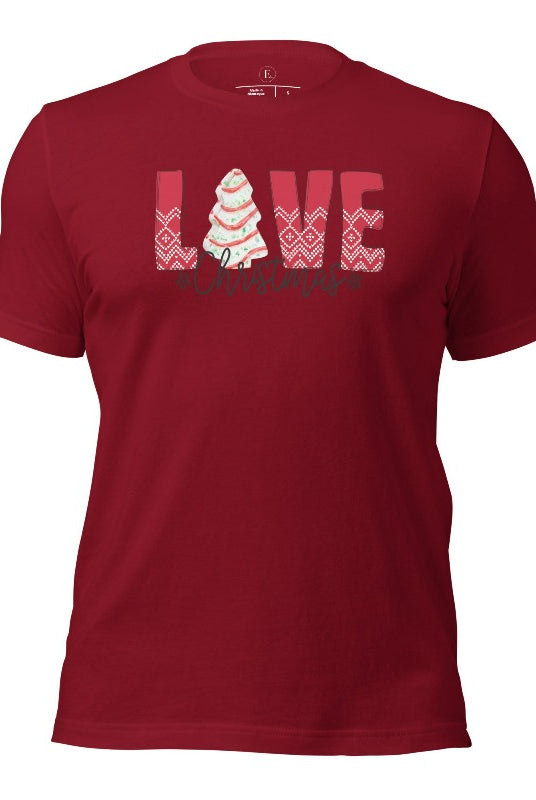 Spread love and joy this holiday season with our Christmas shirt featuring the classic Christmas tree cake, which is incorporated into the word "Love" on a cardinal colored shirt.
