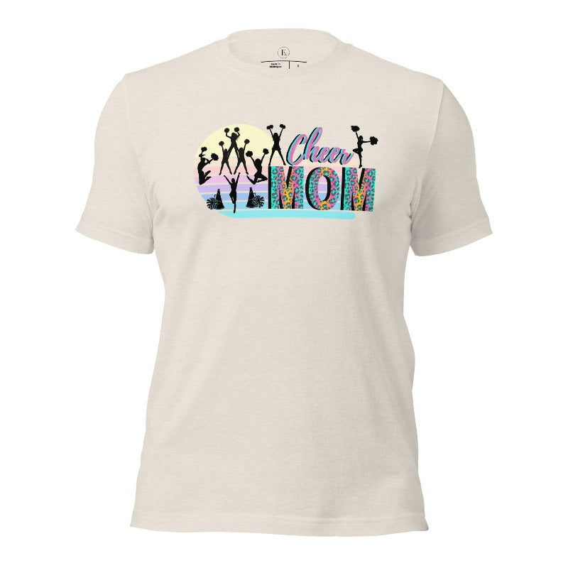 Get your cheer on with our stylish cheer mom shirt. Perfect for proud moms supporting their cheering stars. Made with love, this shirt combines comfort and fashion, letting you show off your team spirit. Join the cheer squad and cheer your heart out in style on a heather dust colored shirt. 