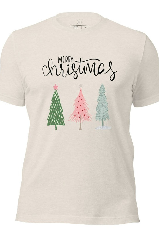 Elevate your festive wardrobe with our trendy shirt and make a chic statement this Christmas. The design features a stylish "Merry Christmas" message along with modern pink and teal Christmas trees on a heather dust shirt. 