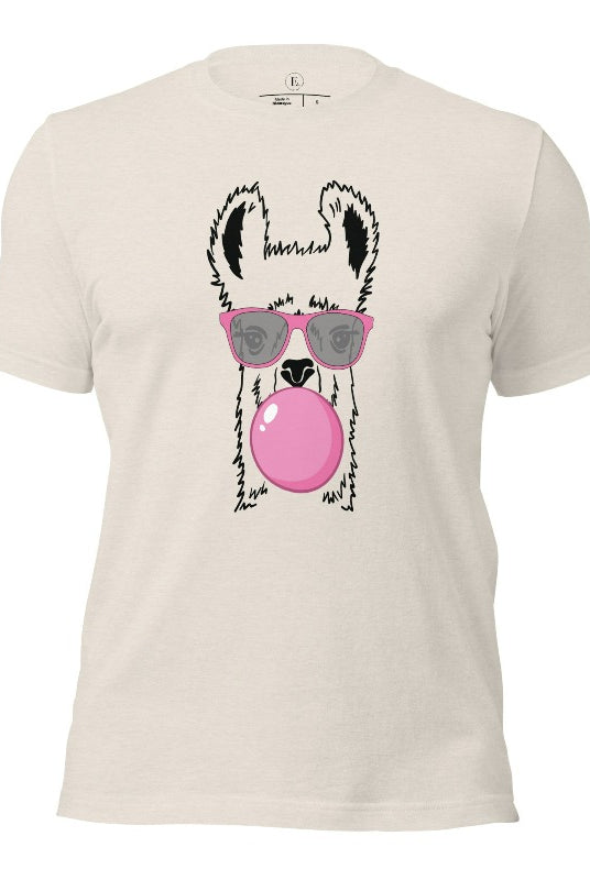 Llama wearing pink sunglasses blowing a bubble gum bubble on a heather dusty colored shirt.
