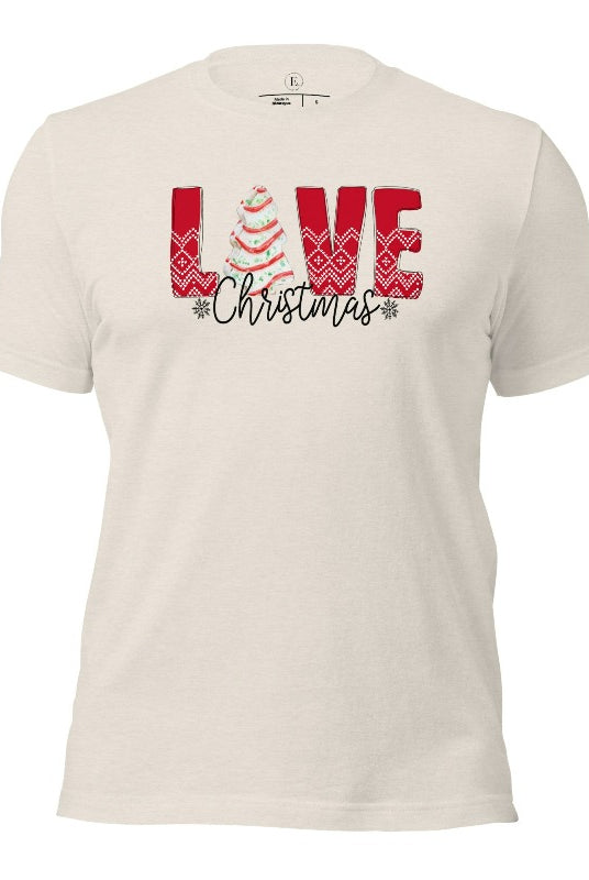 Spread love and joy this holiday season with our Christmas shirt featuring the classic Christmas tree cake, which is incorporated into the word "Love" on a heather dust colored shirt.