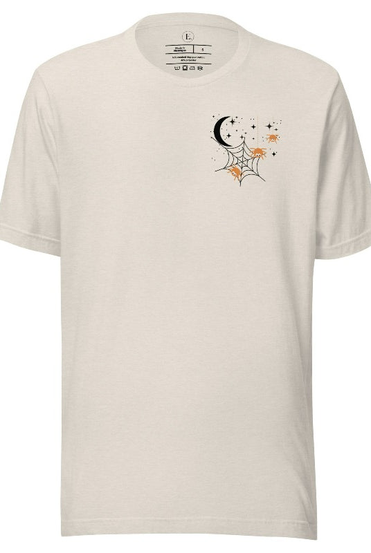 Embrace the enchanting night sky with our captivating t-shirt. Featuring a crescent moon, stars, and a spiderweb with three adorable spiders hanging down on the front pocket on a heather dust colored shirt. 