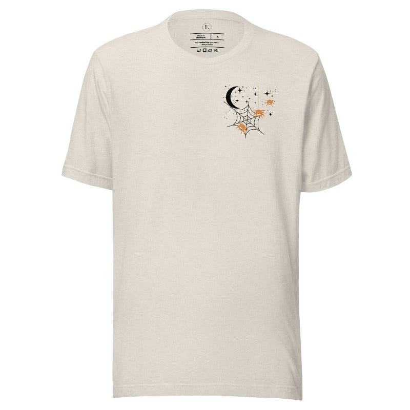 Embrace the enchanting night sky with our captivating t-shirt. Featuring a crescent moon, stars, and a spiderweb with three adorable spiders hanging down on the front pocket on a heather dust colored shirt. 
