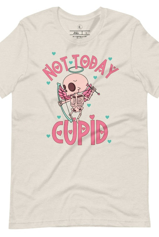 Unleash your rebellious spirit this Valentine's Day with our edgy shirt featuring a skeleton Cupid. The bold "Not Today Cupid" message adds a touch of attitude, making this tee a standout choice for those who march to the beat of their own drum on a heather dust colored shirt. 