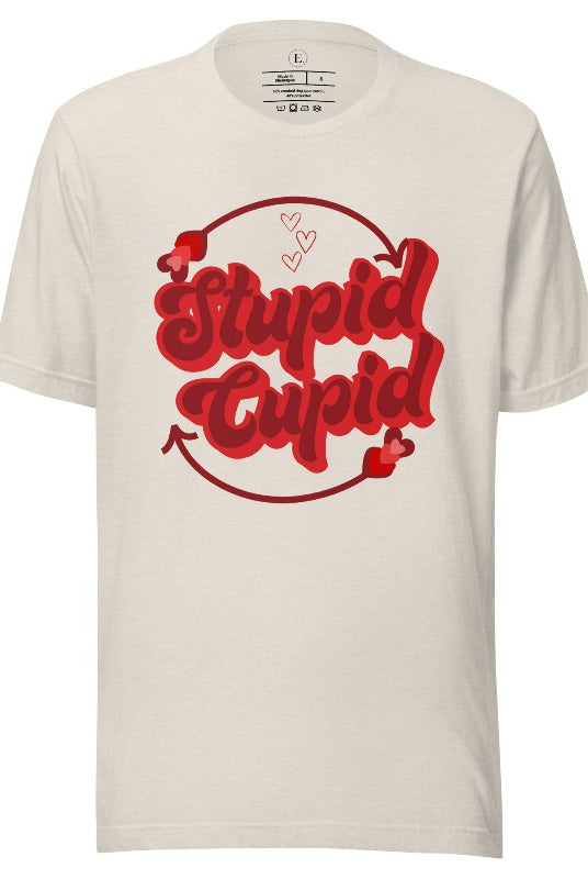 Express your Valentine's Day attitude with our bold and cheeky shirt proclaiming "Stupid Cupid" on a heather dust colored shirt. 