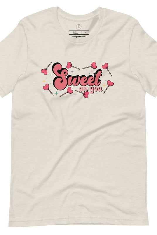 Spread the love with our charming Valentine's Day shirt featuring the endearing phrase " Sweet on You" surrounded by heart lollipops on a heather dust shirt. 