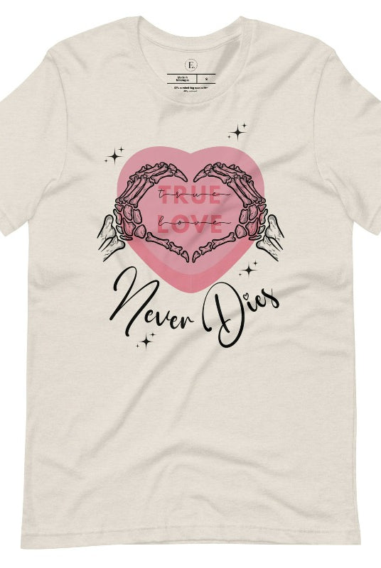 Embrace the unconventional with our Valentine's Day shirt featuring the bold statement "True Love, Never Dies" adorned with a heart and skeleton hands forming a heart shape on a heather dust colored shirt. 