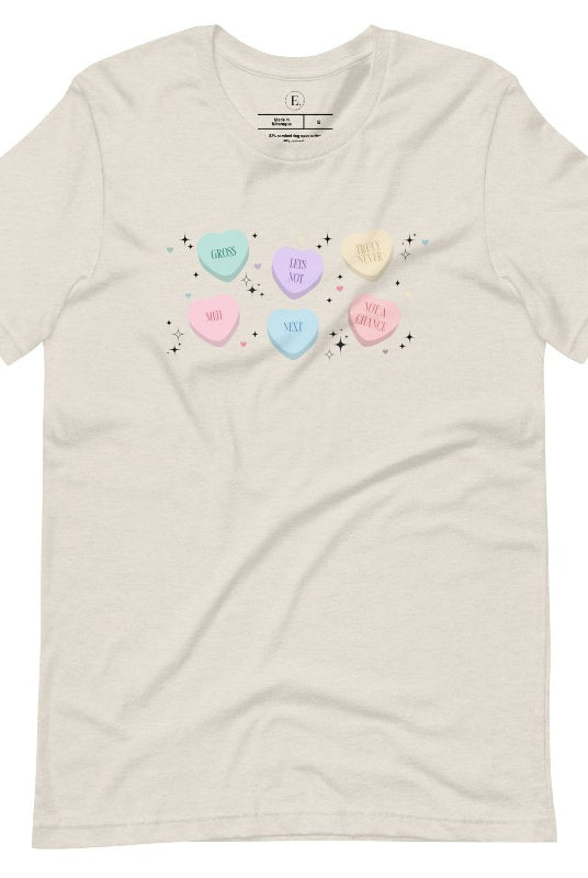 Embrace a humorous take on Valentine's Day with our shirt featuring candy hearts with unconventional messages like "Gross," "Not a Chance," "Next," "Truly Never," "Meh," "Not a Chance," and "Let's Not" on a heather dust colored shirt. 