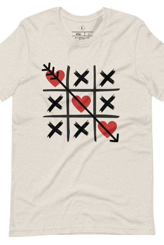 Add a playful twist to Valentine's Day with our Tic-Tac-Toe shirt featuring exes and three hearts. The winning move, an arrow through the three hearts, adds a cheeky touch to this fun and stylish heather dust colored shirt. 