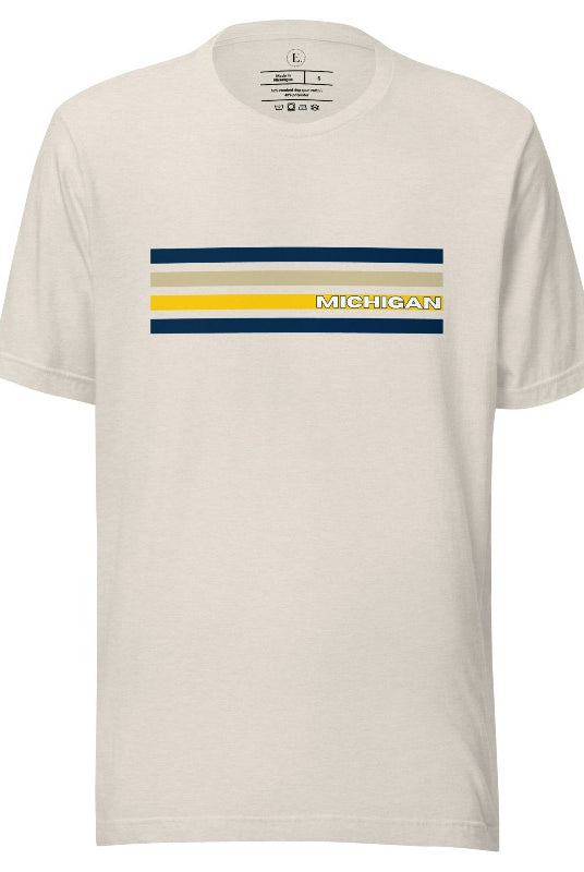 Revive retro collegiate fashion with our Michigan graphic tee. Bosting classic school colors and minimalist design, this men's shirt features distinctive chest stripes with "Michigan" in bold block lettering on a heather dust colored shirt. 