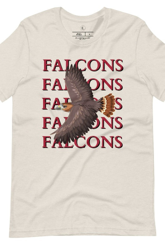 Get ready to soar with style in our Bella Canvas 3001 unisex graphic t-shirt! Featuring a bold Falcon illustration, on a heather dust colored shirt. 