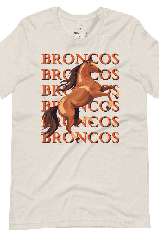 Saddle up for game day fun with our Bella Canvas 3001 unisex graphic tee! Gallop into Broncos spirit with our exclusive design featuring a lively Bronco horse and the spirited mantra "Broncos Broncos Broncos Broncos" on a heather dust colored shirt. 