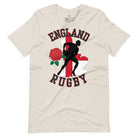 Introducing our England Rugby Graphic T-Shirt - the ultimate fusion of patriotism, rugby pride, and contemporary style! This captivating t-shirt features the words "England Rugby" and the iconic England flag artfully incorporated within the outline of the country, accompanied by a dynamic rugby player graphic on a heather dust colored shirt. 