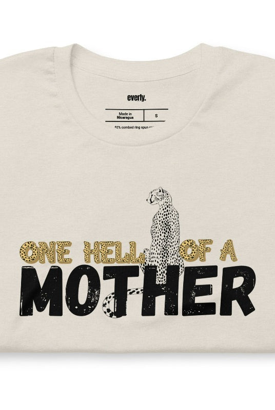 "One Hell of a Mother" Graphic Tee - The Ultimate Mama Shirt for Stylish Moms on a cream graphic tees. 