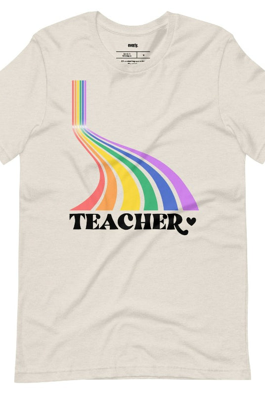 Colorful rainbow design with the word 'teacher' at the bottom, showcased on a teacher graphic tee. The perfect choice for teacher shirts and teacher gifts. Cream graphic tees.