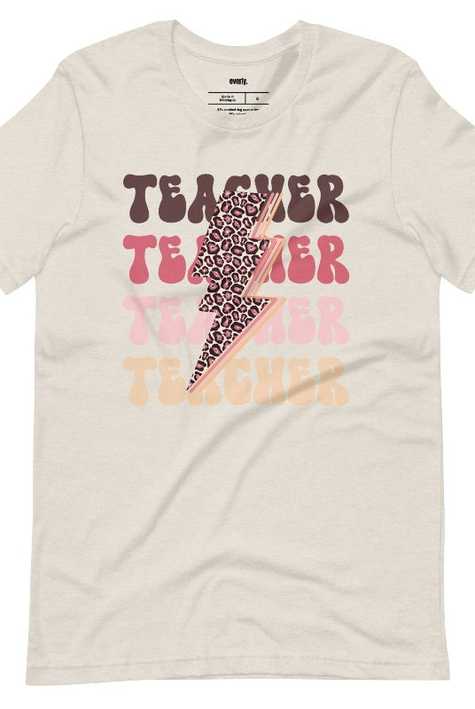 Cream teacher graphic tee with pink cheetah lightning bolt and the word 'teacher' - perfect for teacher shirts and teacher gifts. Eye-catching graphic tee for educators.