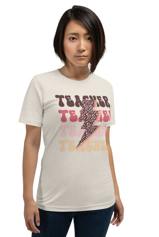 Cream teacher graphic tee with pink cheetah lightning bolt and the word 'teacher' - perfect for teacher shirts and teacher gifts. Eye-catching graphic tee for educators.