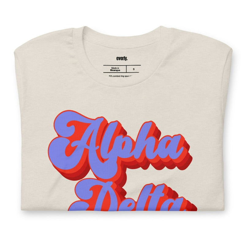 Heather dust graphic tee featuring 'Alpha Delta Chi' in retro lettering