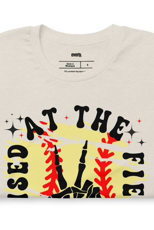 Raised at the field softball retro design on a heather dust graphic tee.