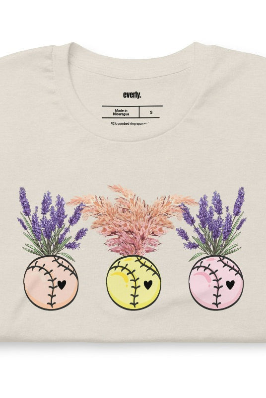 Softball flower vases holding flowers on a heather dust graphic tee.