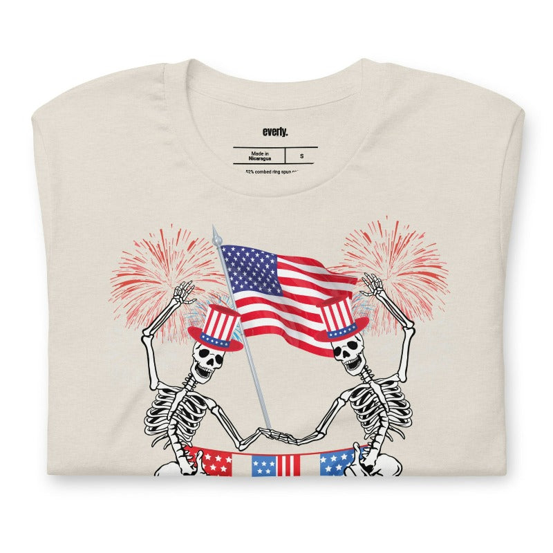 Skeletons celebrating July 4th heather dust graphic tee.