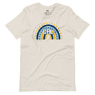 Bella + Canvas 3001 unisex t-shirt featuring a playful blue and gold rainbow design with "CAL" in the center, surrounded by hearts and dots on a beige graphic tee.