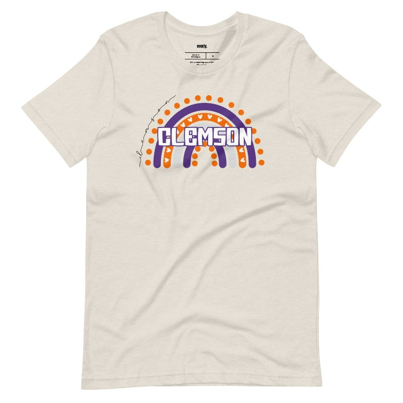 Bella + Canvas 3001 unisex shirt featuring a colorful rainbow design with the word "Clemson" in the center, representing Clemson University on a beige graphic tee.