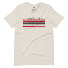 A vibrant NC State design with "North Carolina State" written in red across the top, stripes in red, black, and white, and "Raleigh, North Carolina" at the bottom on a beige graphic tee.