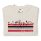 A vibrant NC State design with "North Carolina State" written in red across the top, stripes in red, black, and white, and "Raleigh, North Carolina" at the bottom on a beige graphic tee.