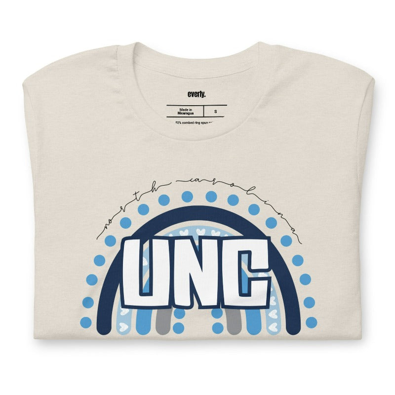 UNC - University of North Carolina design with blue and white motifs on a beige shirt.