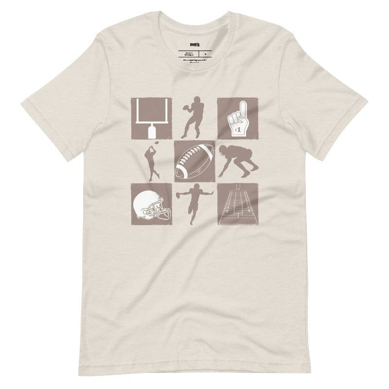 a design with various football-related icons, including a helmet, football, goalpost, players, and a "#1" foam finger, in a monochromatic brown tone on a beigee shirt.