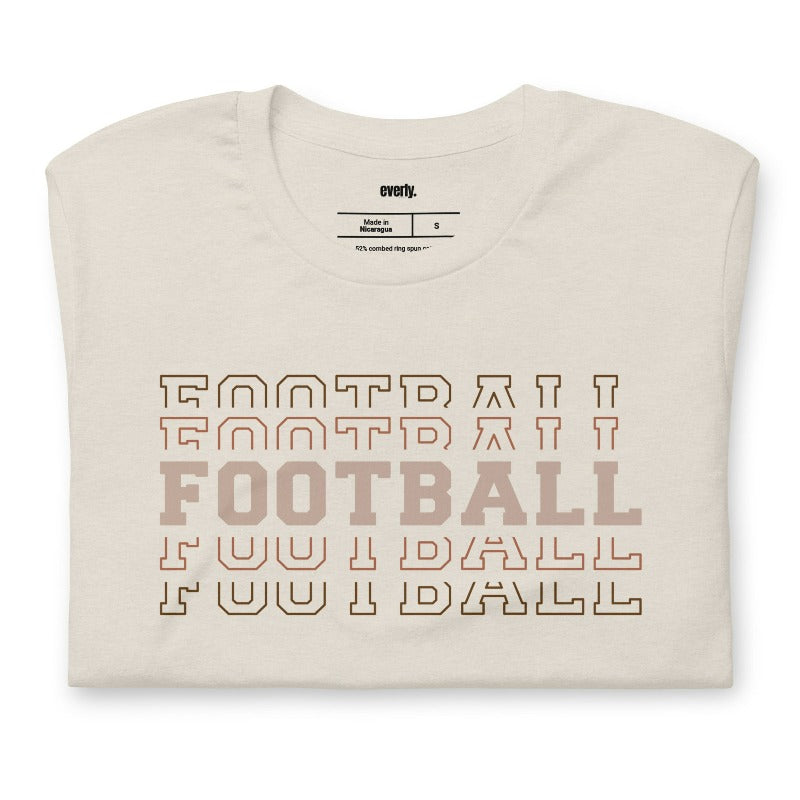 "FOOTBALL" repeated in different shades of brown and tan, with each instance of the word displayed in a slightly different style on a beige shirt.