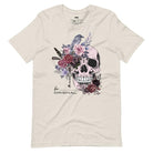 A Halloween-themed design with a skull adorned with flowers and a raven, accompanied by the text "Be Original." The shirt is soft and perfect for celebrating Halloween in style on a beige shirt.