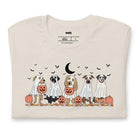 White t-shirt featuring a row of dogs dressed in ghost costumes with pumpkins, perfect for Halloween fun and dog lovers.