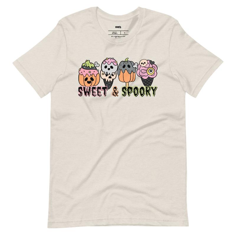 Beige t-shirt featuring a fun 'Sweet & Spooky' design with Halloween-themed ice cream cones, skulls, pumpkins, and spooky treats.