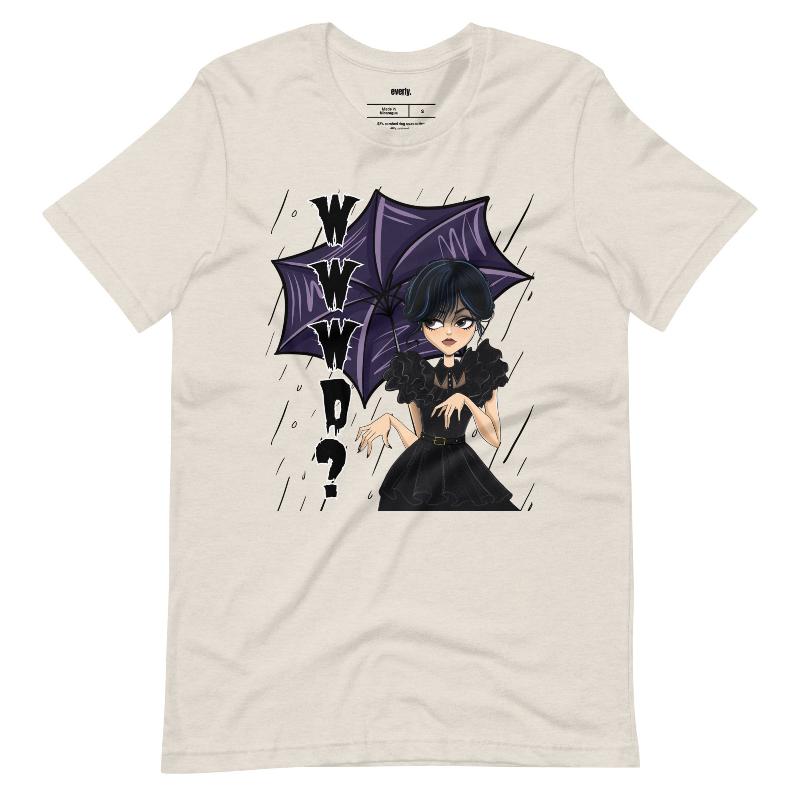 Beige t-shirt featuring a stylish goth girl dressed in black with a purple umbrella, along with the text "WWWD?" (What Would Wednesday Do?) in bold lettering.