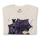 Beige t-shirt featuring a stylish goth girl dressed in black with a purple umbrella, along with the text "WWWD?" (What Would Wednesday Do?) in bold lettering.