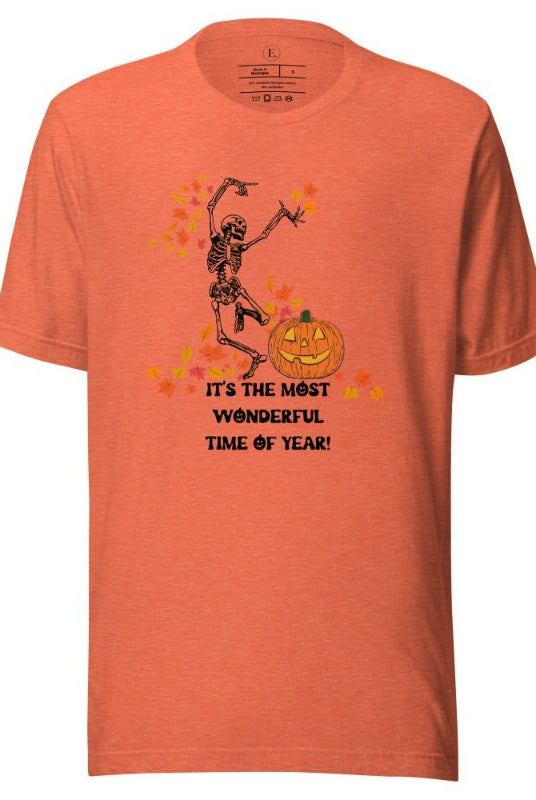 Dancing Skeleton in fall leaves with a jack-o-lantern with saying "It's the most wonderful time of year" on a heather orange colored shirt.