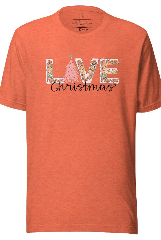 Get ready to celebrate the holiday season in style with our Christmas shirt featuring cute gingerbread cookies arranged to spell out the word "Love" on a heather orange colored shirt.