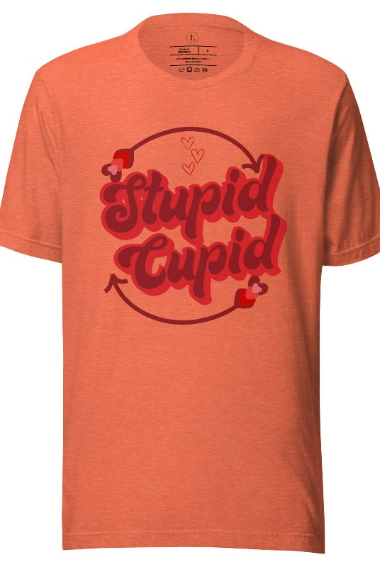 Express your Valentine's Day attitude with our bold and cheeky shirt proclaiming "Stupid Cupid" on a heather orange shirt. 