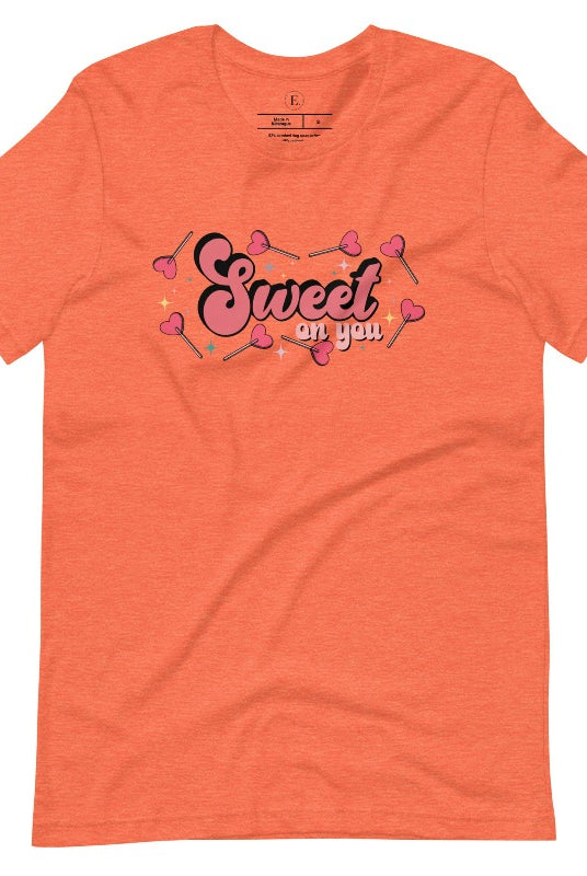 Spread the love with our charming Valentine's Day shirt featuring the endearing phrase " Sweet on You" surrounded by heart lollipops on a heather orange shirt.