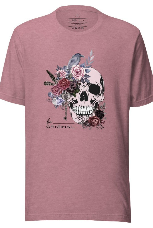 Looking for a unique Halloween shirt? Look no further! Our hauntingly beautiful shirt features a floral skull, raven, and the empowering slogan 'Be Original'. Stand out from the crowd with this unforgettable statement piece on a heather orchid colored shirt. 